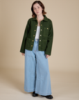 Hana is wearing Denim Work Jacket in Evergreen and light wash Indigo Wide Leg Trousers