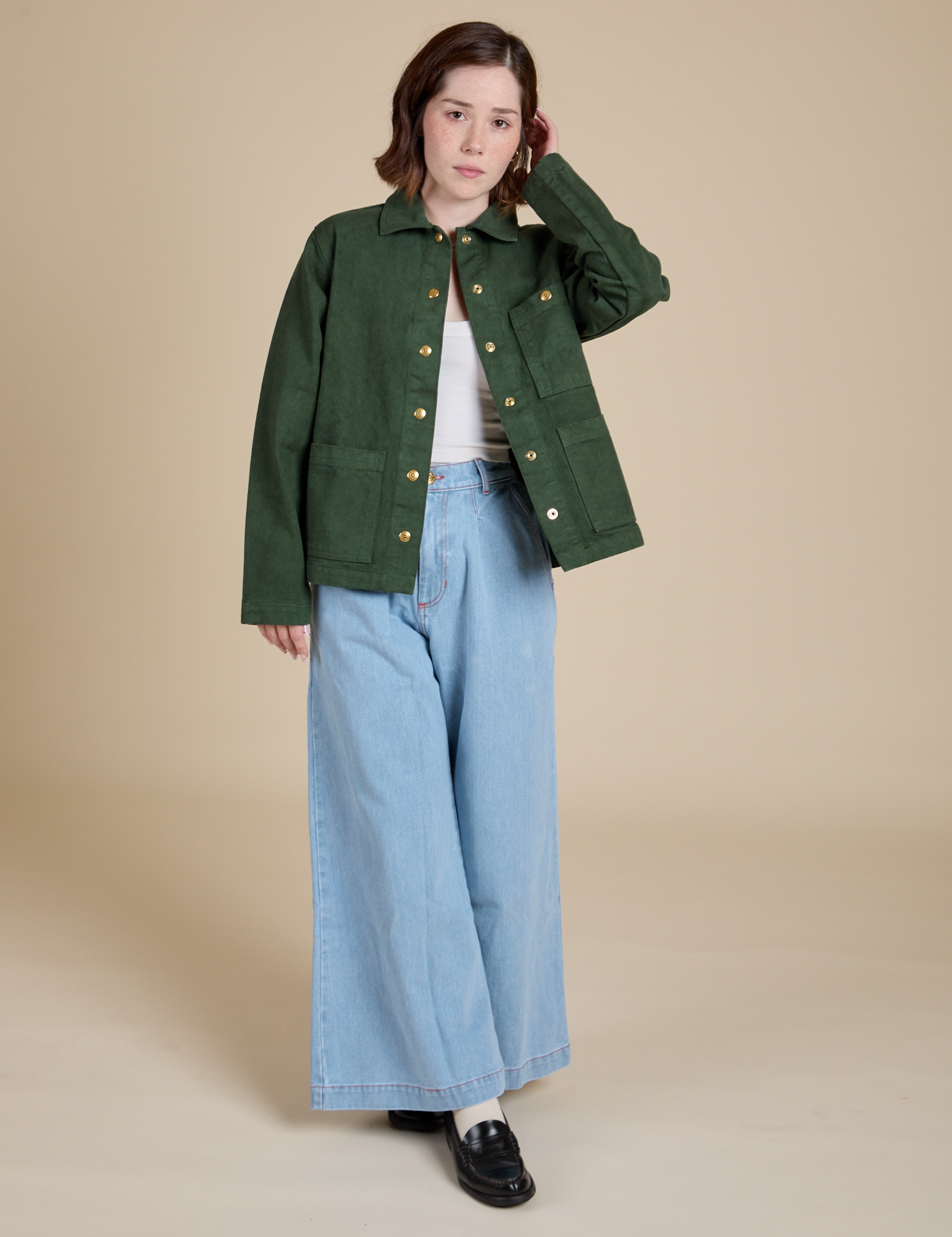 Hana is wearing Denim Work Jacket in Swamp Green and light wash Indigo Wide Leg Trousers