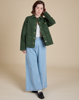 Hana is wearing Denim Work Jacket in Swamp Green and light wash Indigo Wide Leg Trousers