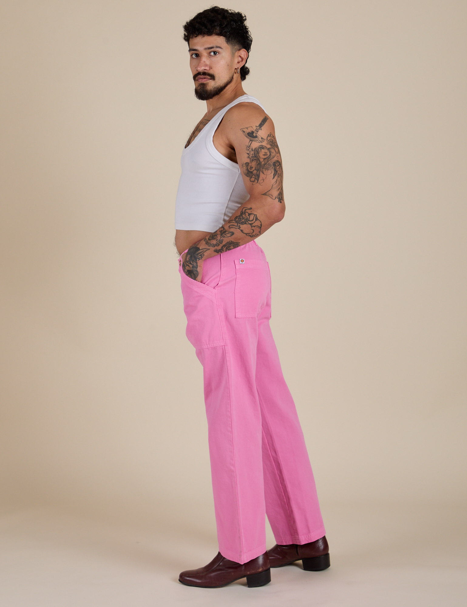 Side view of Work Pants in Bubblegum Pink and vintage tee white Cropped Tank on Jesse