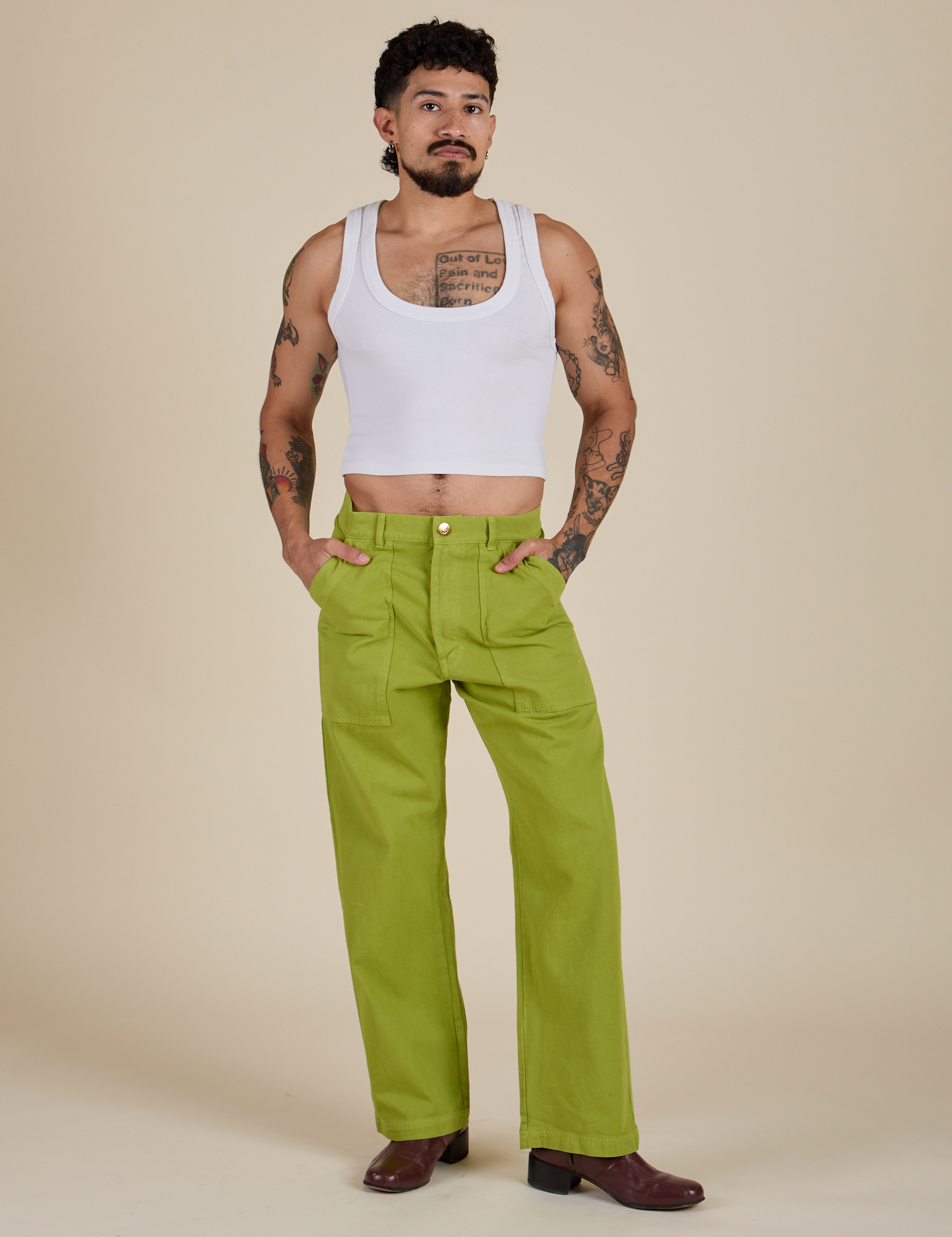 Jesse is 5’8” and wearing S Work Pants in Gross Green paired with a Cropped Tank in Vintage Tee White