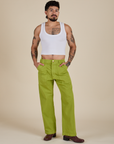 Jesse is 5’8” and wearing S Work Pants in Gross Green paired with a Cropped Tank in Vintage Tee White