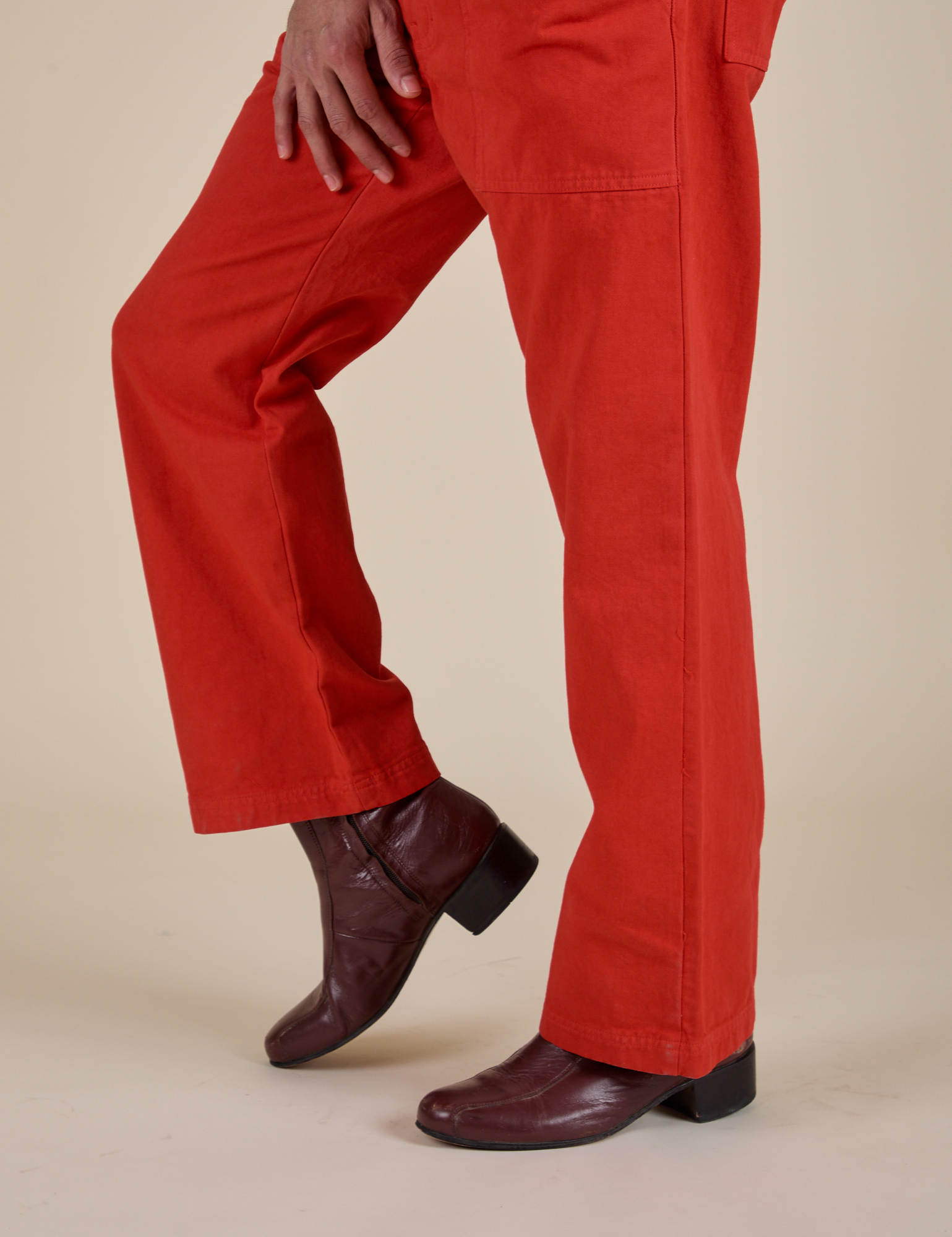 Work Pants in Mustang Red close up pant leg side view on Jesse