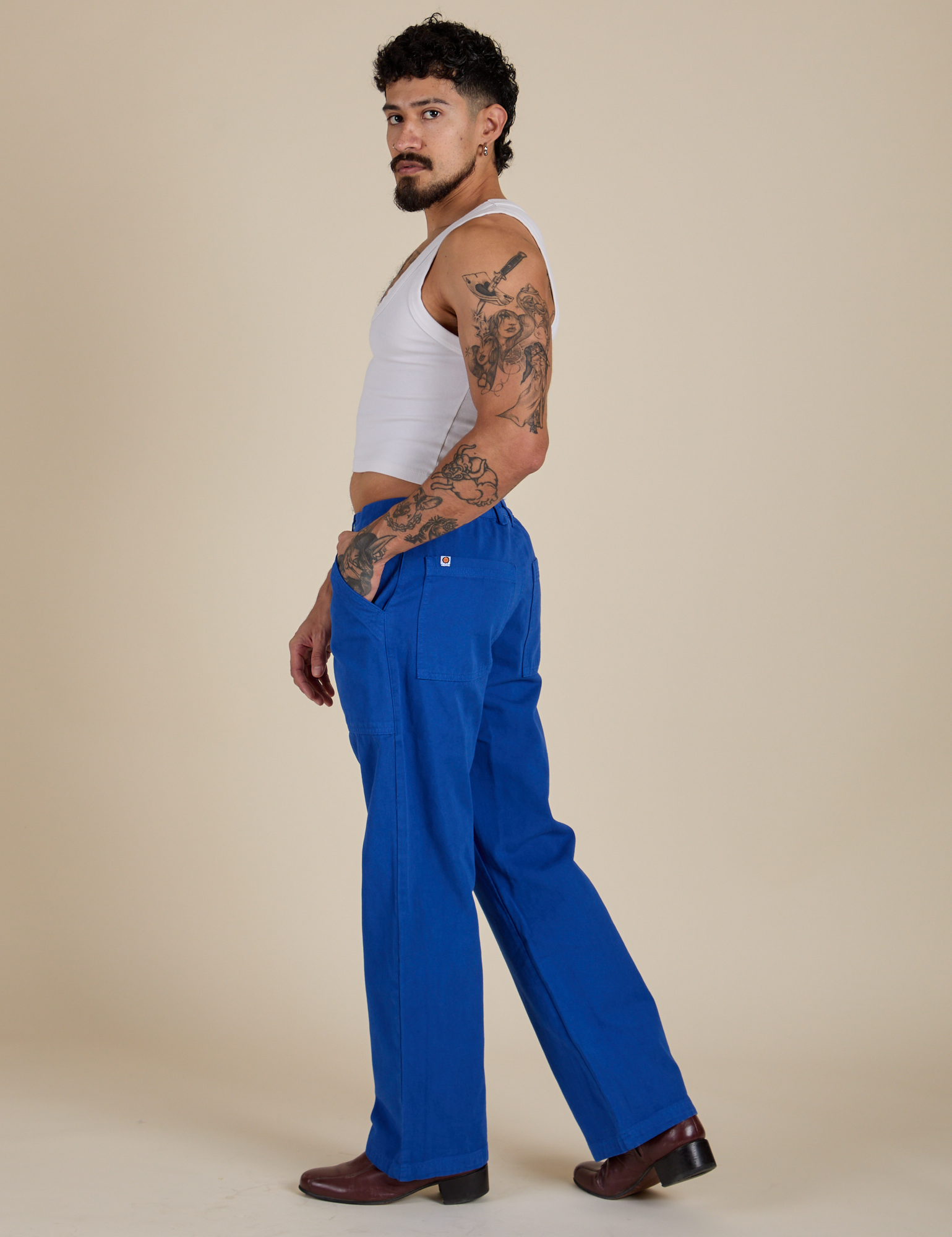 Side view of Work Pants in Royal Blue and Cropped Tank in Vintage Tee White on Jesse