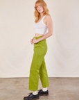 Side view of Work Pants in Gross Green and Cropped Tank in vintage tee off-white on Margaret