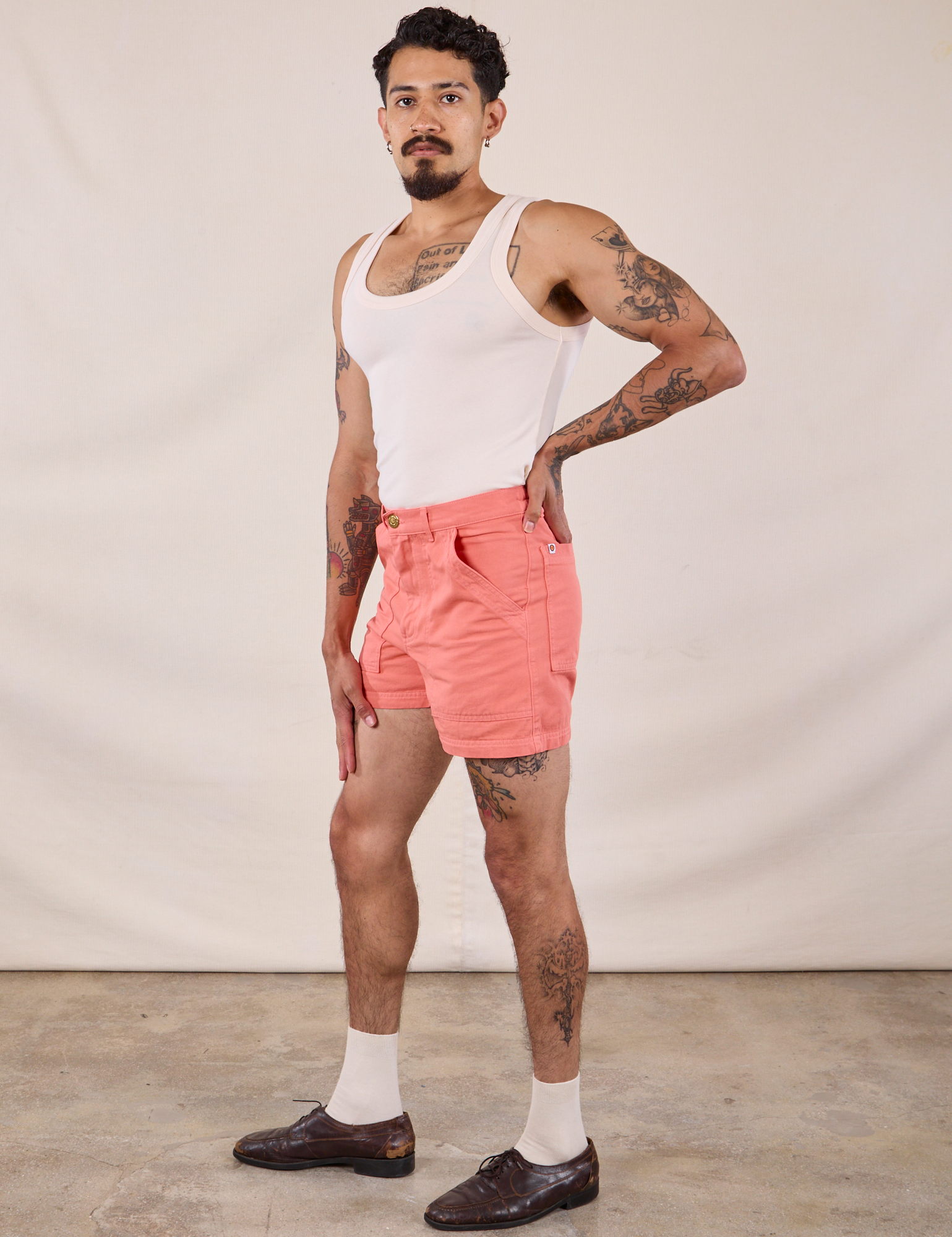 Side view of Classic Work Shorts in Flamingo Pink and Tank Top in Vintage Tee Off-White on Jesse