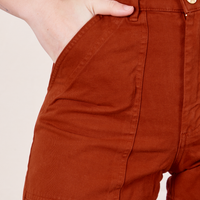 Classic Work Shorts in Paprika front close up. Alex has her hand in the pocket.