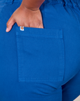 Close up of Morgan's hand in the back pocket of Western Pants in Royal Blue