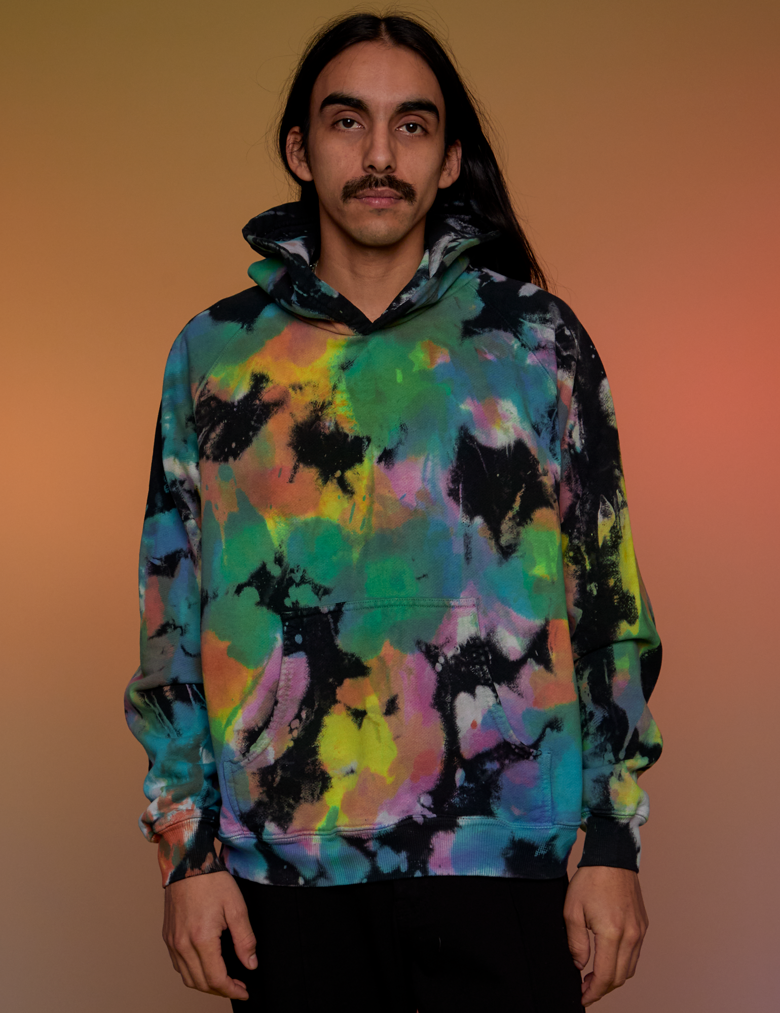 Anthony is 5’6” and wearing S Oversized Hoodie in Rainbow Magic Waters