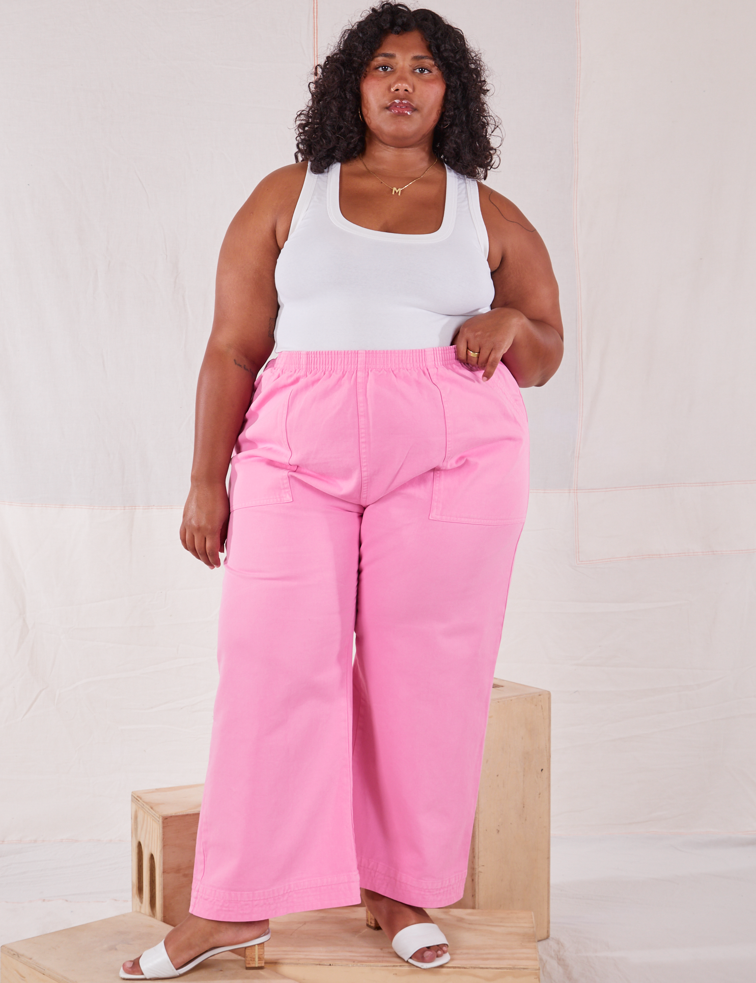 Morgan is 5&#39;5&quot; and wearing 2XL Action Pants in Bubblegum Pink paired with a Tank Top in vintage tee off-white