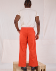 Back view of Action Pants in Chili Red and Organic Vintage Tee in Vintage Tee Off-White on Isaac