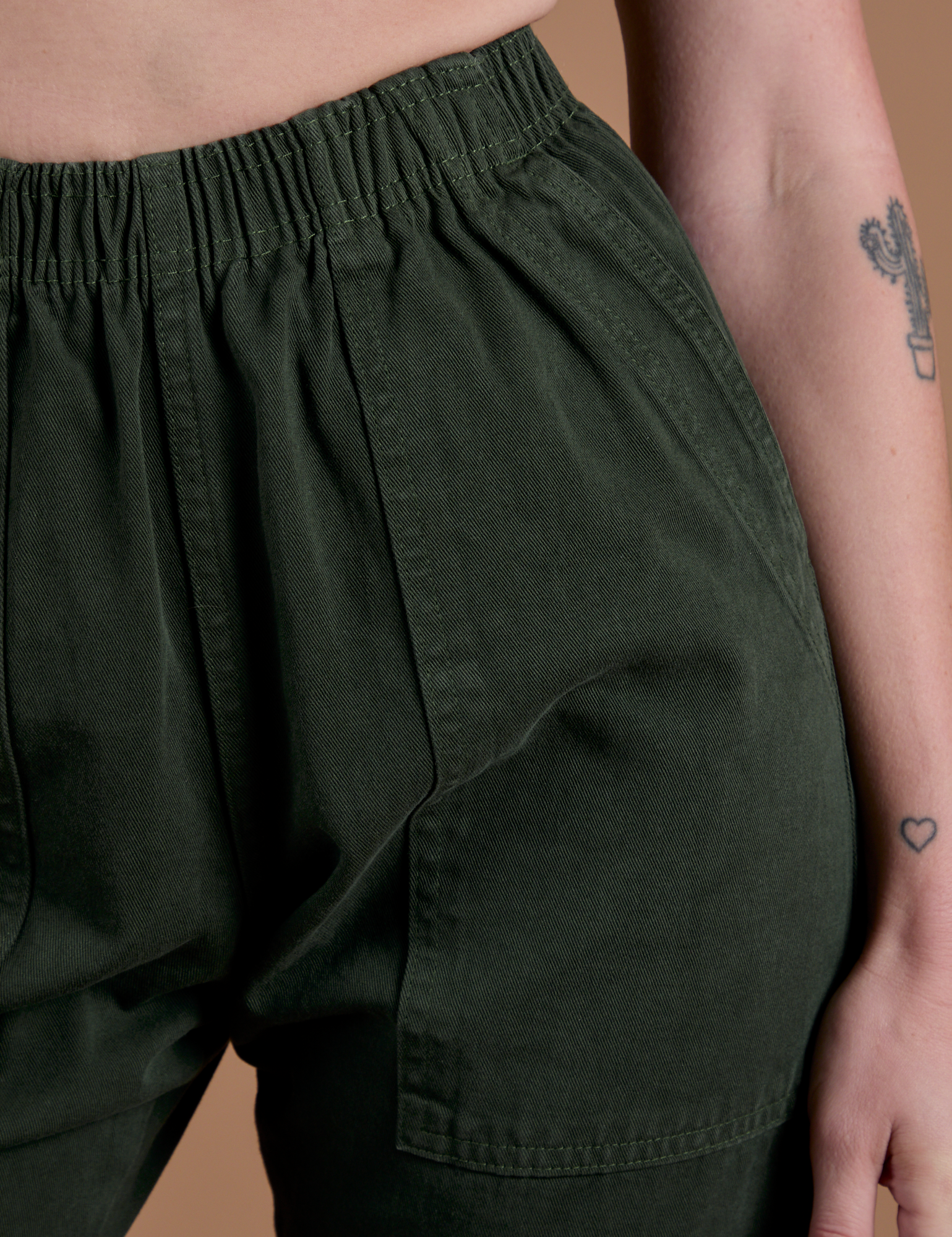 Action Pants in Swamp Green front close up on Alex
