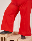 Bell Bottoms in Mustang Red pant leg close up on Sam