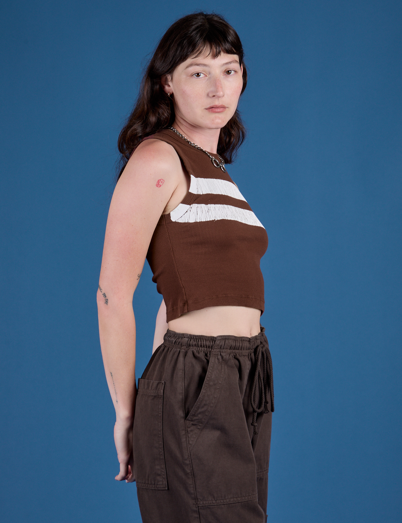 Painted Muscle Tee in Fudgesicle Brown side view on Alex