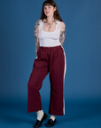 Sydney is 5’9” and wearing M Painted Action Pants in Red Wine paired with vintage tee white Cropped Tank