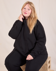 Juliet is wearing Oversized Hoodie in Basic Black