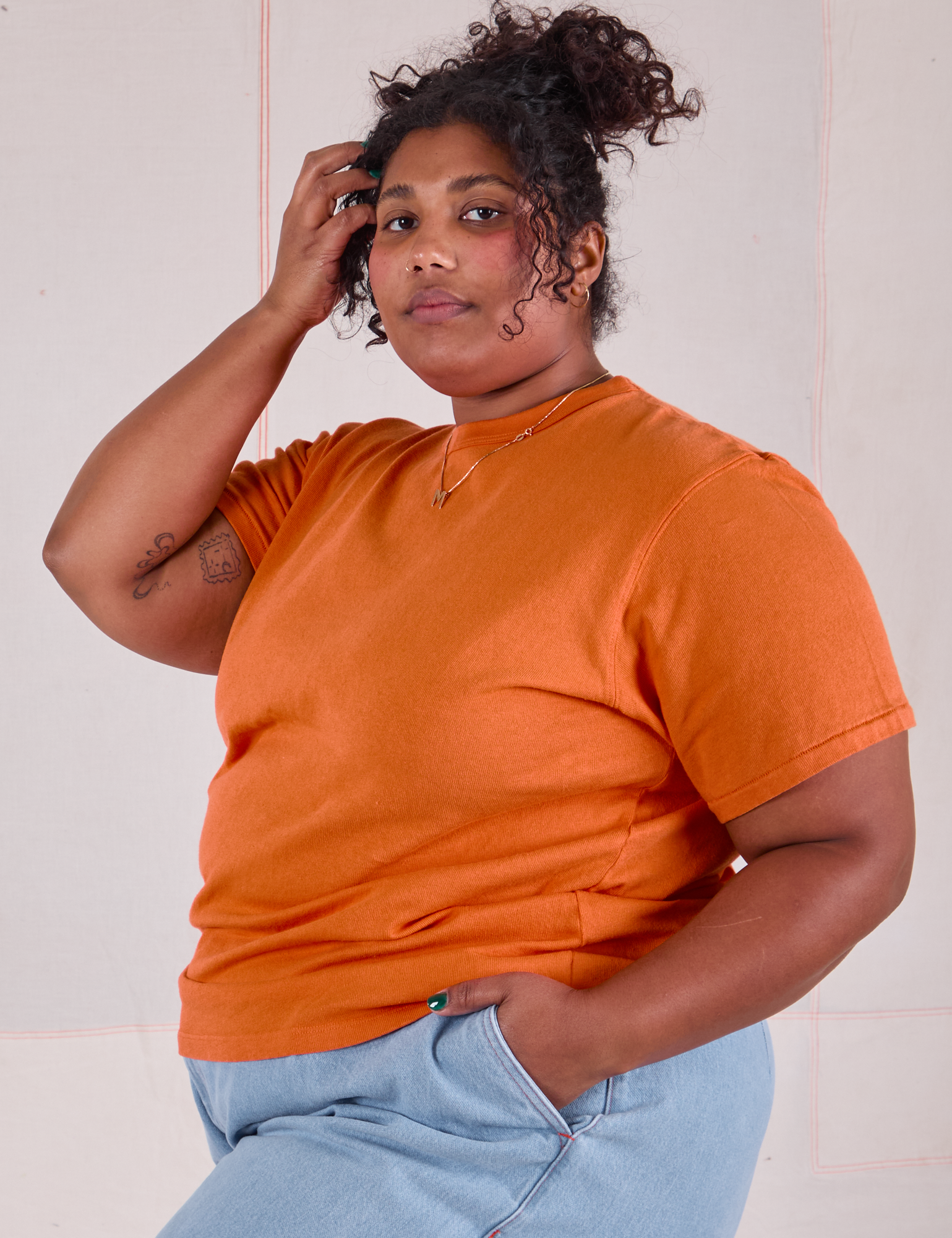 Morgan is 5&#39;5&quot; and wearing XL Burly Tee in Construction Orange