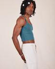 Side view of Cropped Cami in Marine Blue and vintage off-white Western Pants worn by Jerrod