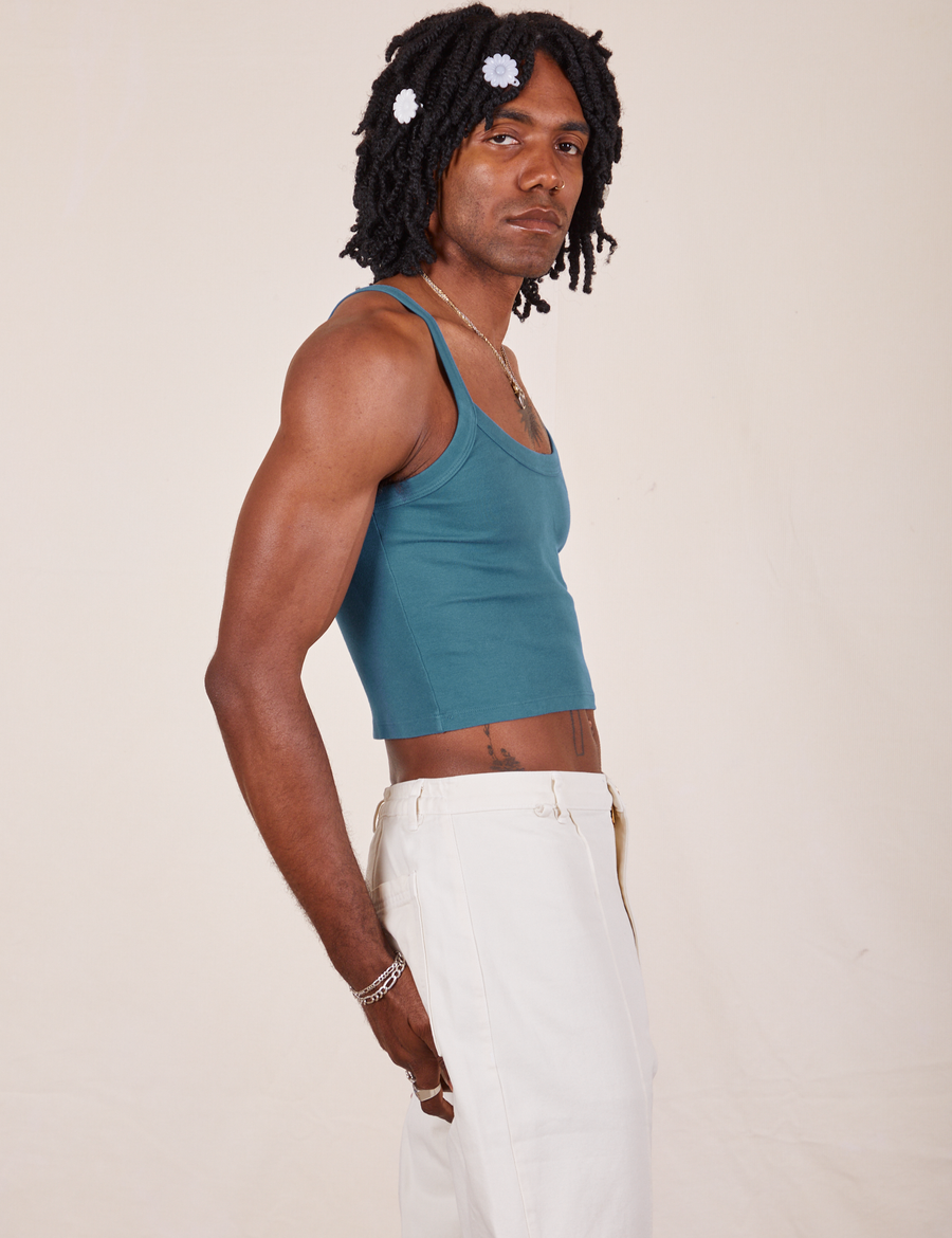 Side view of Cropped Cami in Marine Blue and vintage off-white Western Pants worn by Jerrod