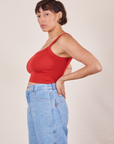 Side view of Cropped Cami in Mustang Red and light wash Sailor Jeans worn by Tiara