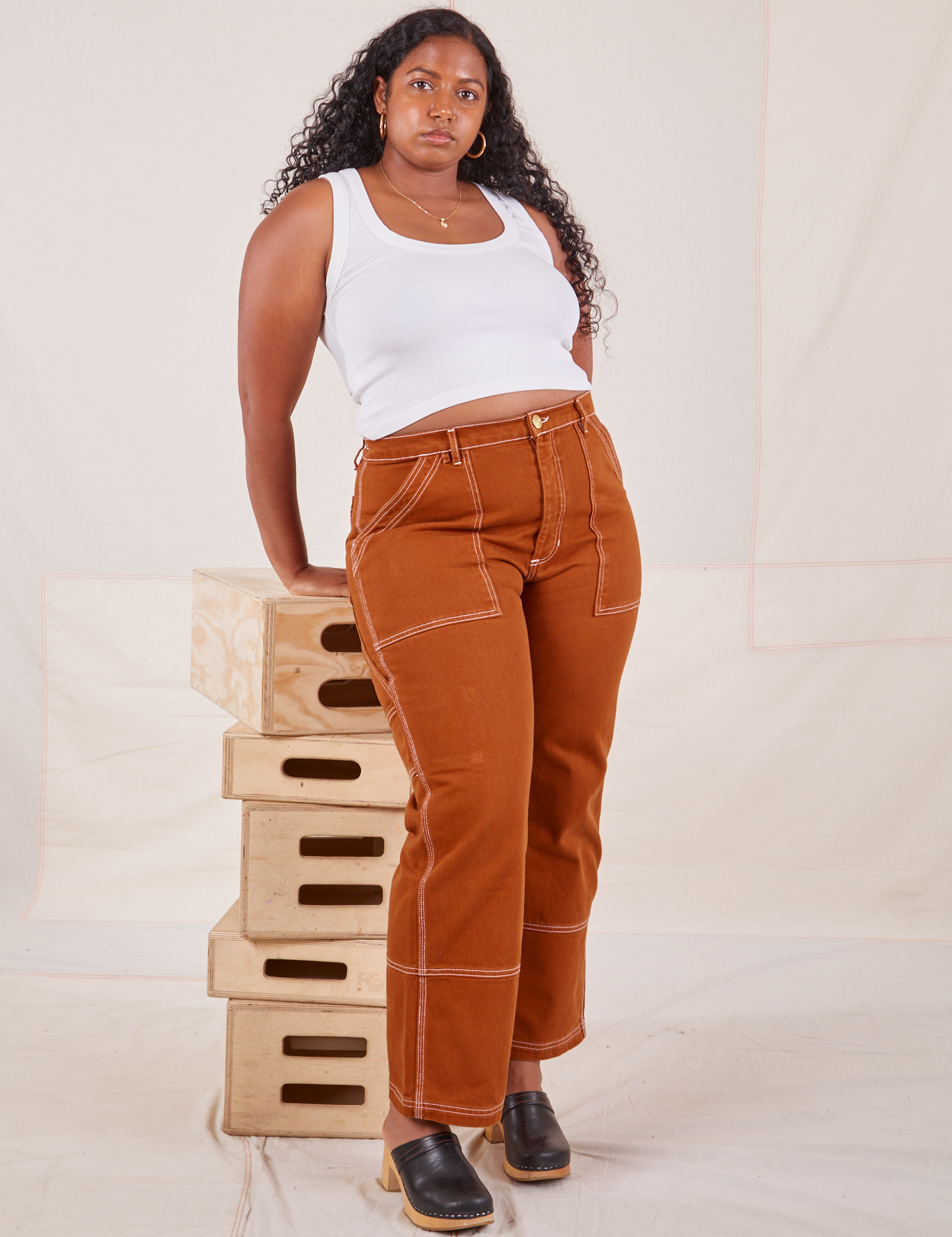 Meghna is wearing Carpenter Jeans in Burnt Terracotta and vintage off-white Cropped Tank Top