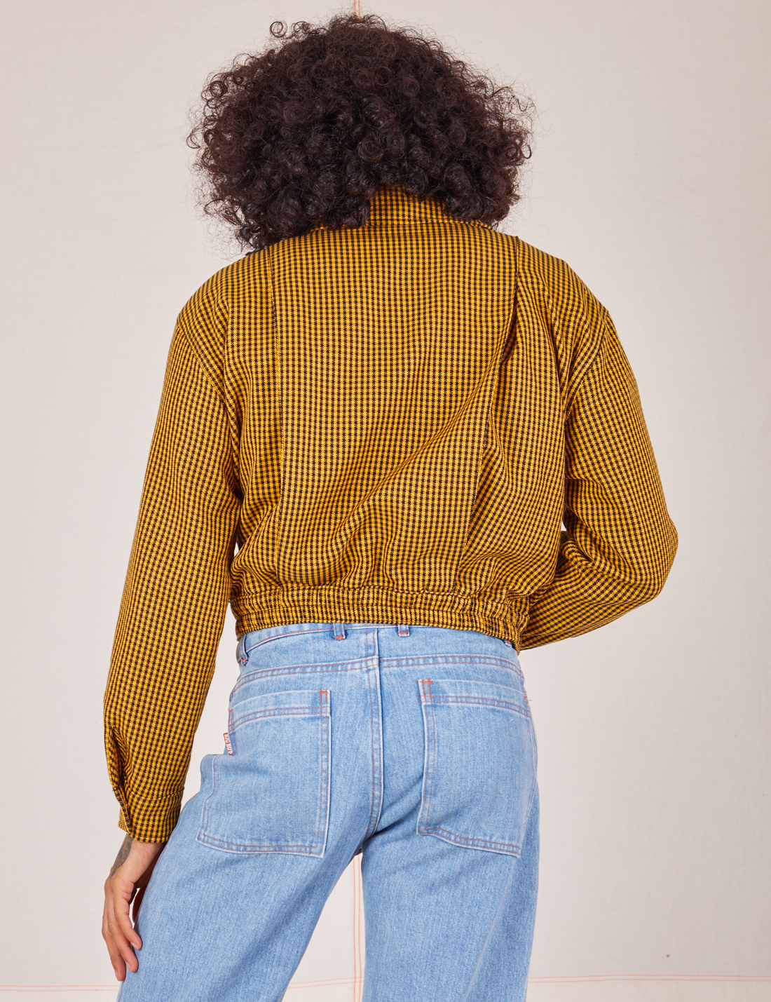 Back view of Ricky Jacket in Checker Yellow worn by Jesse