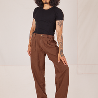 Jesse is wearing Checker Trousers in Brown and black Baby Tee