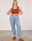 Lish is wearing Cropped Tank Top in Burnt Terracotta and light wash Carpenter Jeans