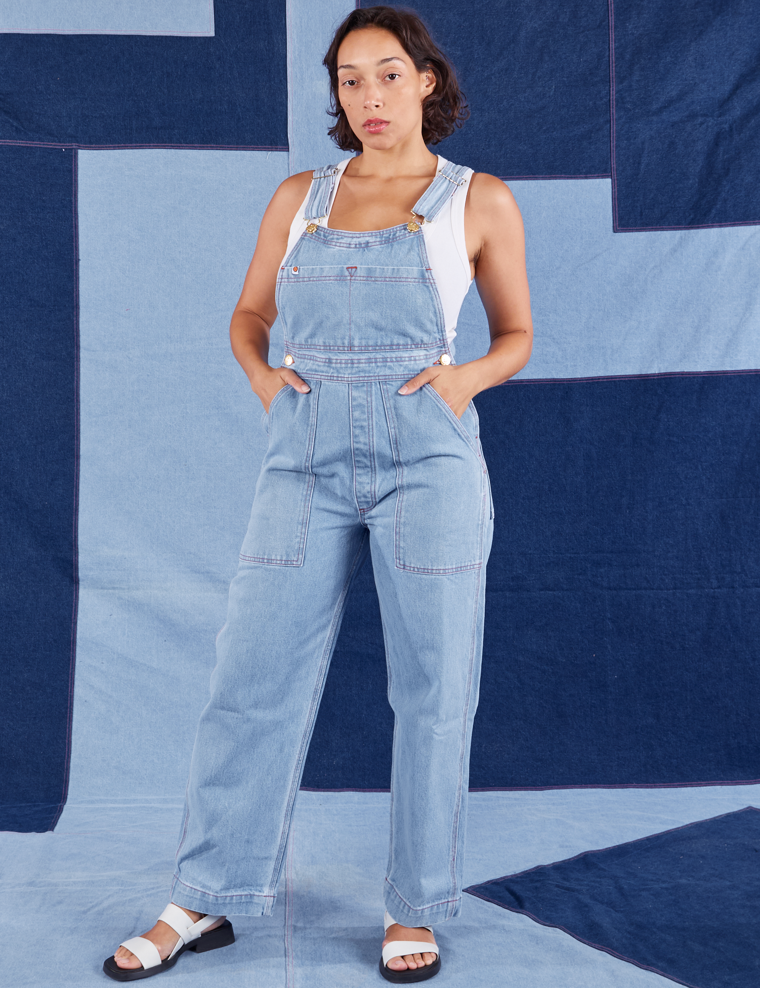 Tiara is 5&#39;4&quot; and wearing XS Indigo Denim Original Overalls in Light Wash