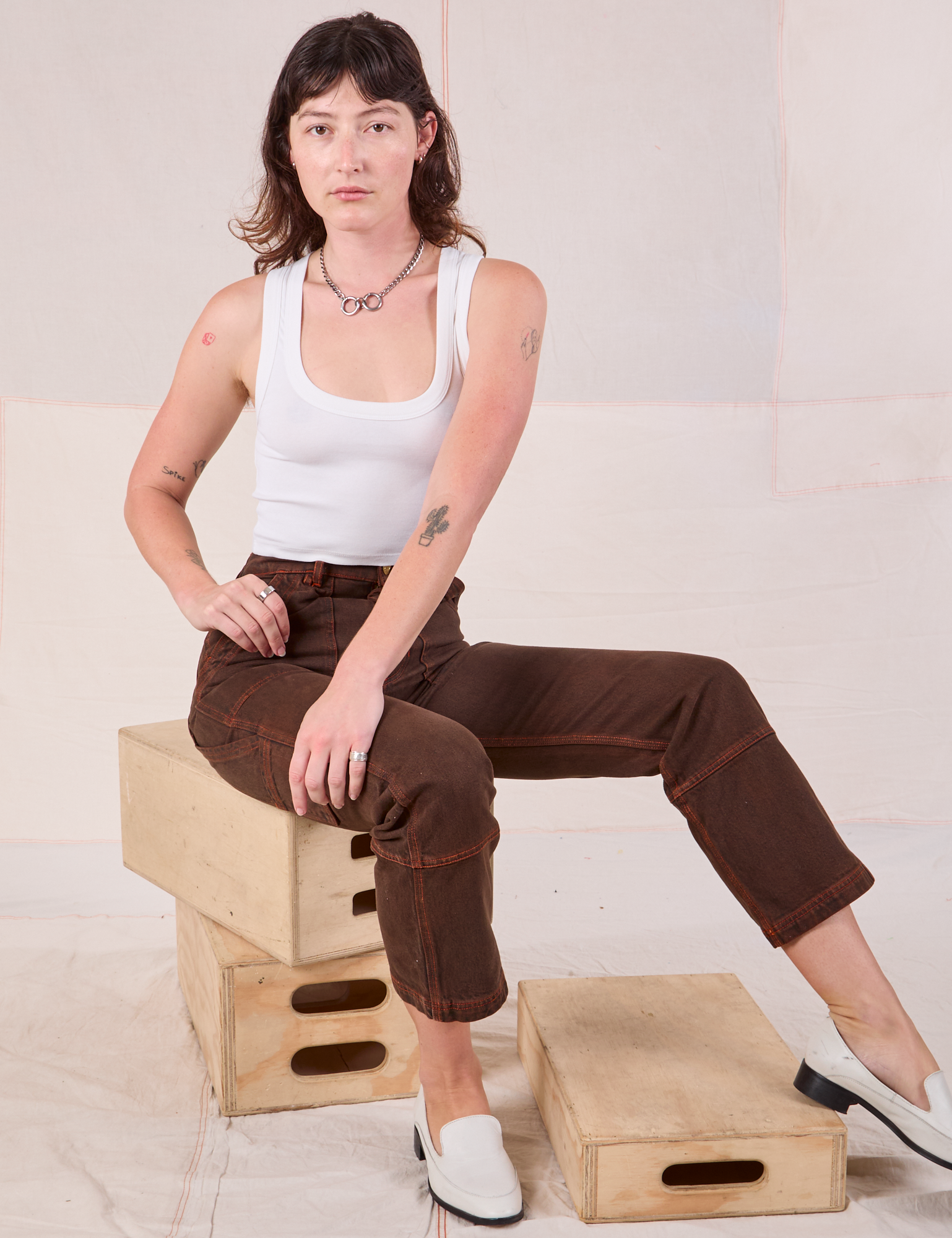 Alex is wearing Overdyed Carpenter Jeans in Fudge and Cropped Tank in vintage tee off-white