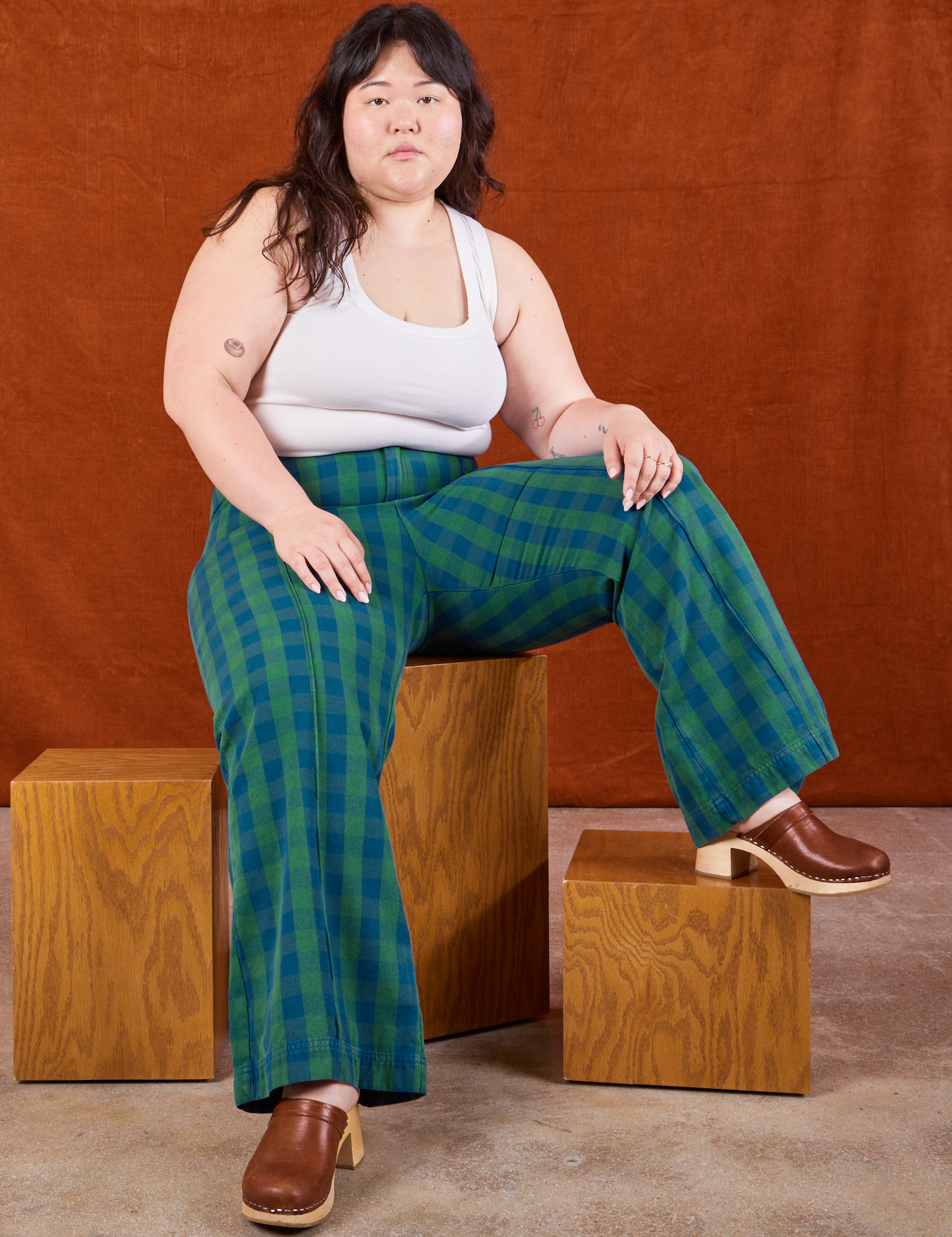 Ashley is wearing Gingham Western Pants in Green and Cropped Tank in vintage tee off-white