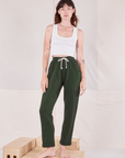 Alex is 5'8" and wearing P Rolled Cuff Sweat Pants in Swamp Green paired with Cropped Tank in vintage tee off-white