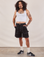 Jesse is 5'8" and wearing S Carpenter Shorts in Basic Black paired with a Cropped Tank in vintage tee off-white
