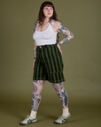 Angled front view of Longline Work Shorts in Evergreen and Cropped Tank in Vintage Tee White