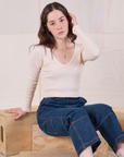 Hana is wearing Long Sleeve V-Neck Tee in Vintage Tee Off-White and dark wash Carpenter Jeans