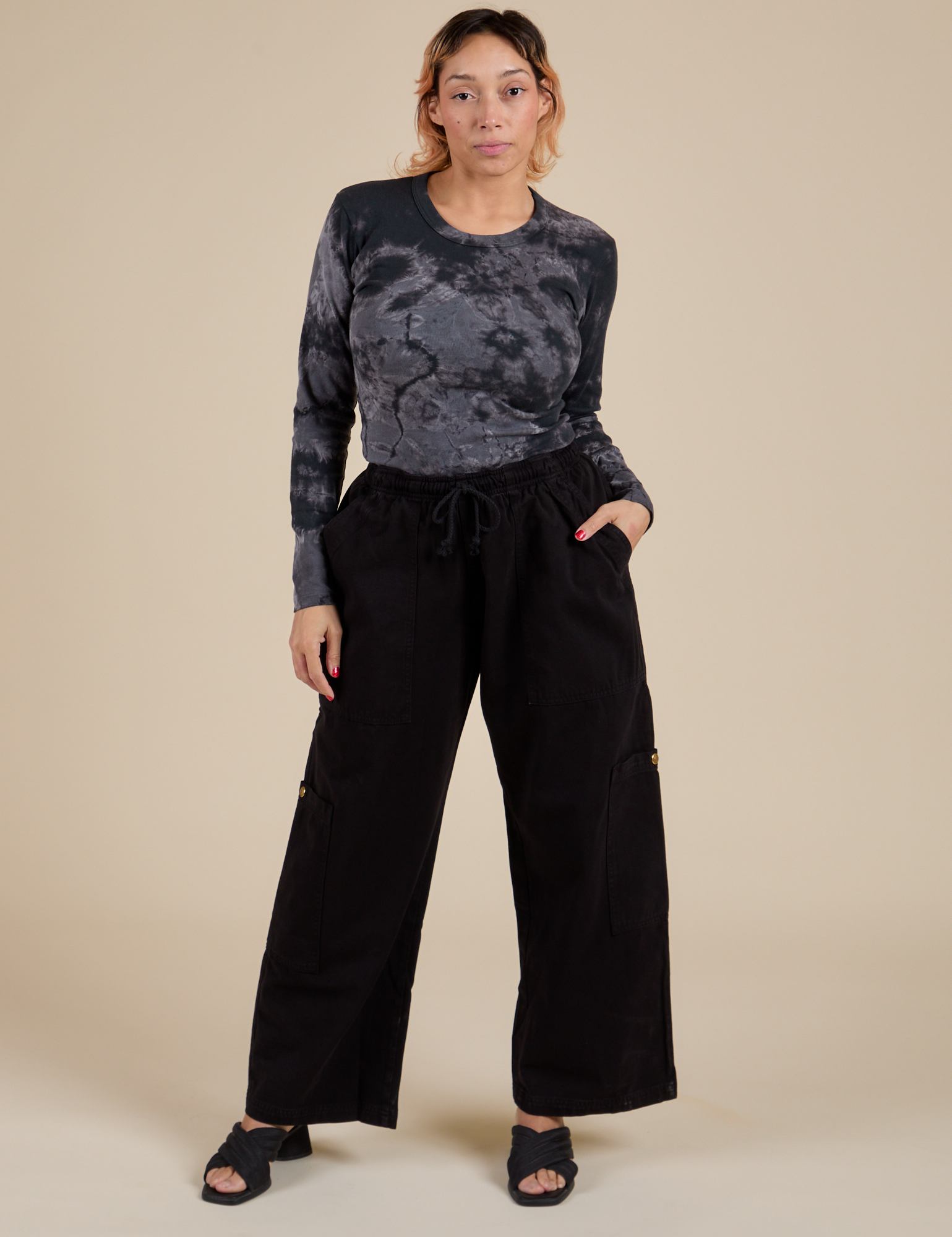 Tiara is waering Long Sleeve Baby Tee in Black Magic Waters and black Drop Pocket Cargo Pants