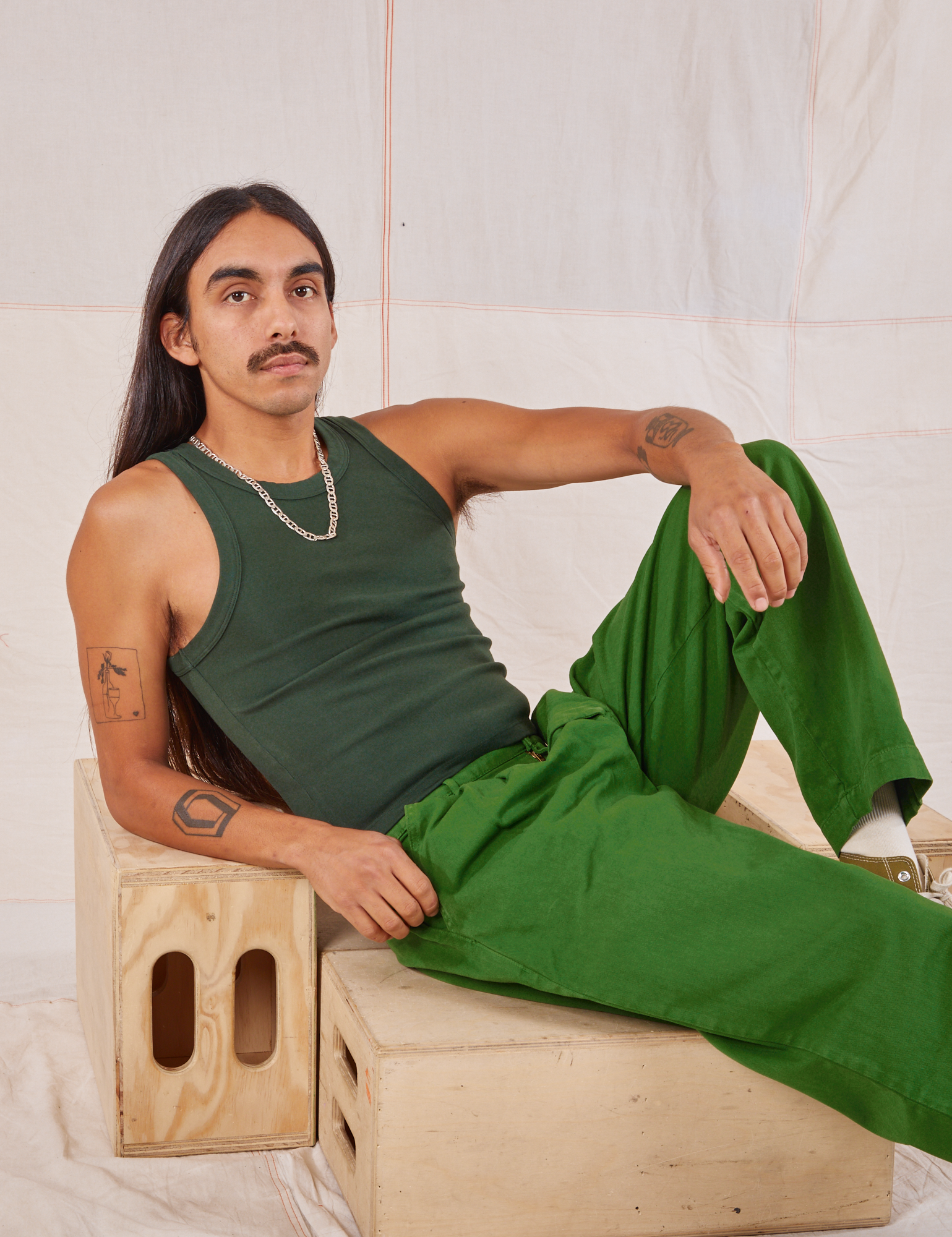 Anthony is wearing Racerback Tank in Swamp Green and lawn green Trousers