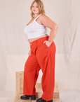 Side view of Mid-Rise Pleated Trousers in Chili Red and Cropped Tank in vintage tee off-white on Juliet