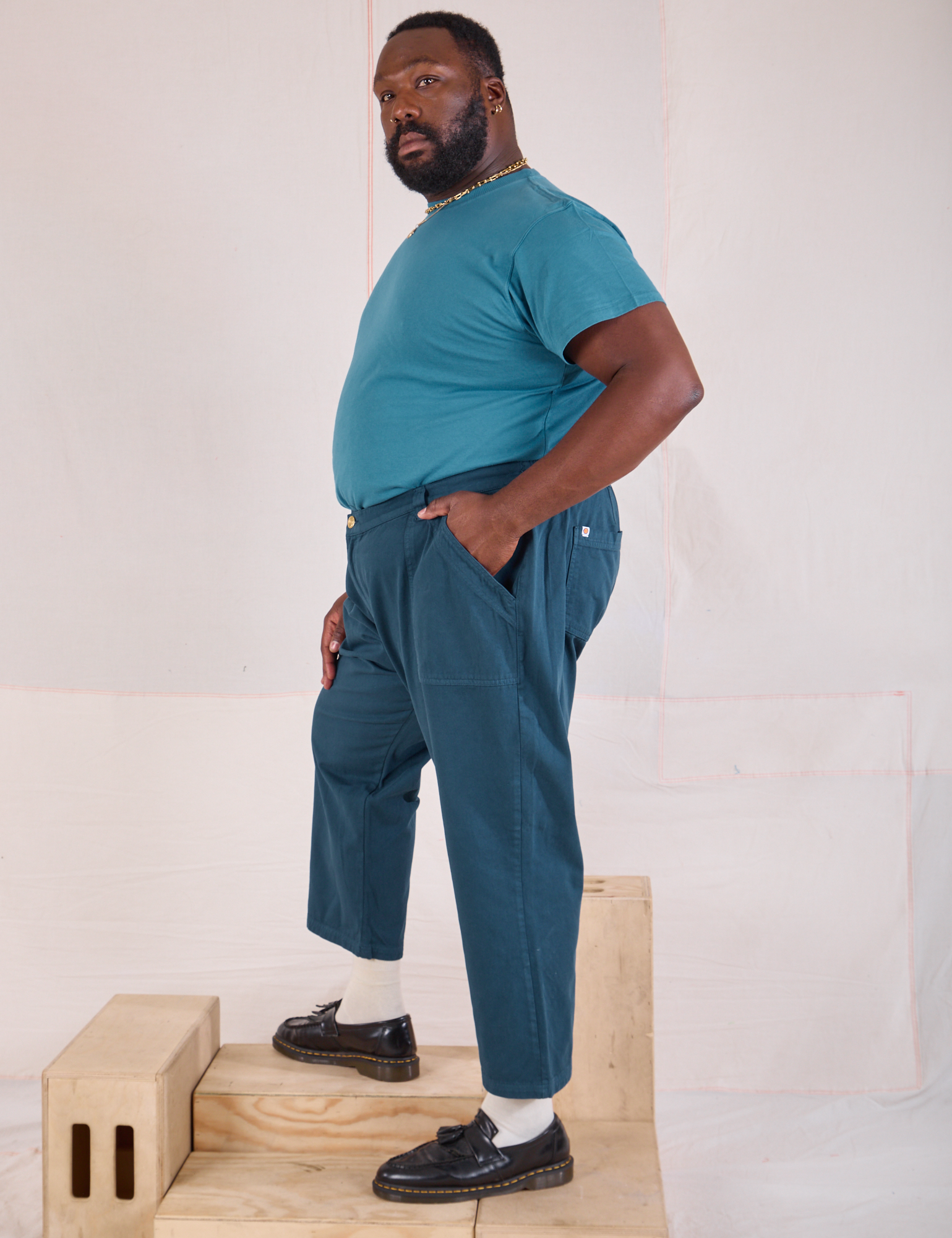 Side view of Mid-Rise Work Pants in Lagoon and marine blue Organic Vintage Tee 