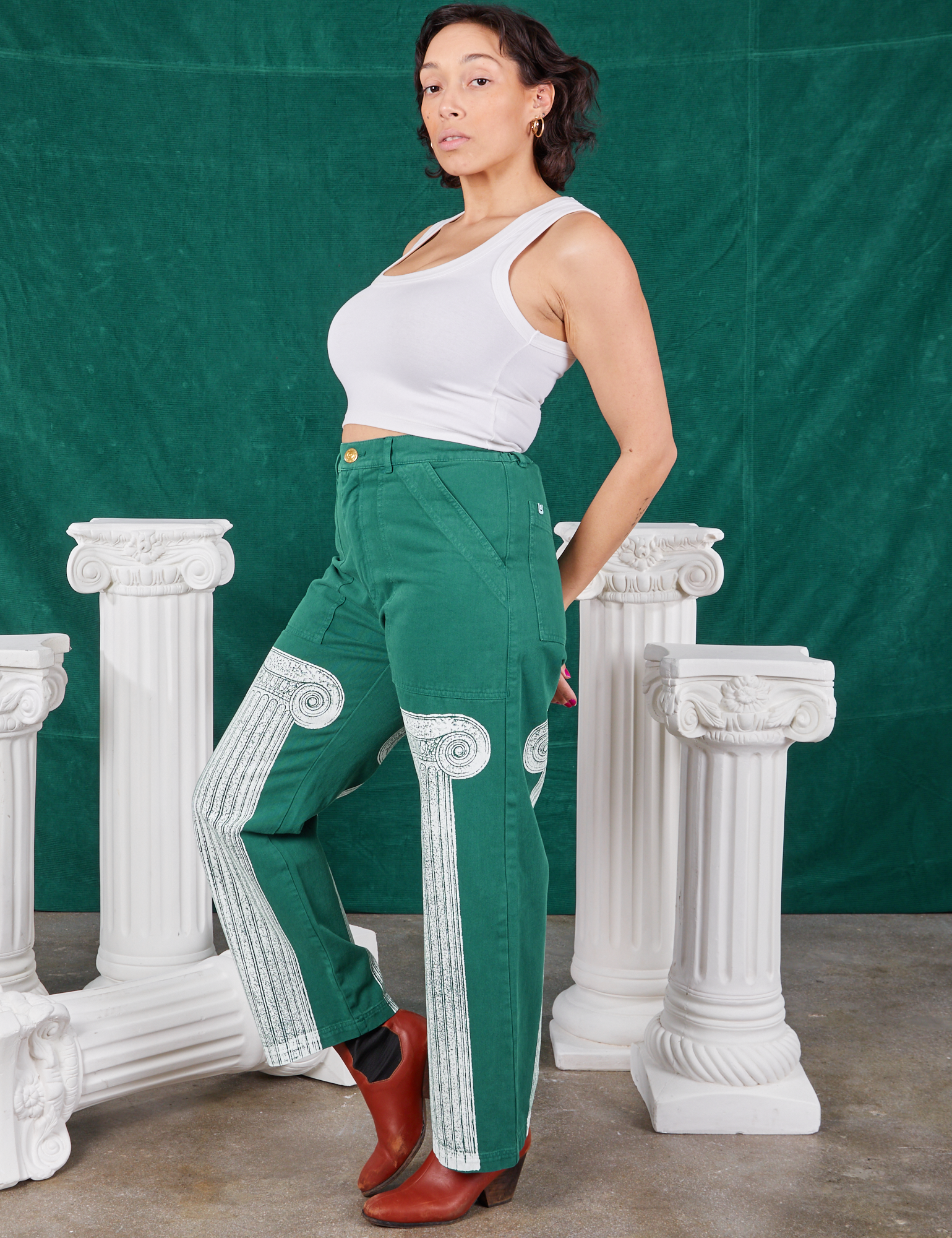 Side view of Column Work Pants in Hunter Green and vintage off-white Cropped Tank Top on Tiara