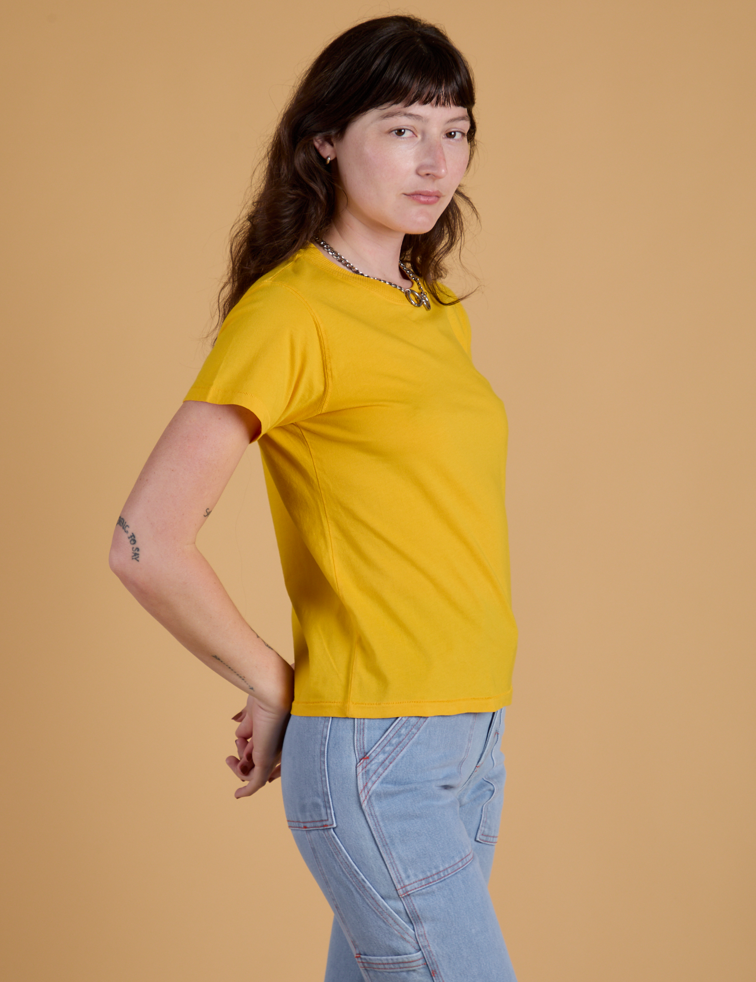 Side view of  Organic Vintage Tee in Sunshine Yellow on Alex