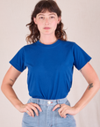 Alex is wearing Organic Vintage Tee in Royal Blue tucked into Carpenter Jeans in Light Wash