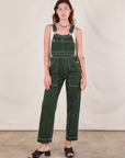 Alex is 5'8"and wearing P Original Overalls in Swamp Green