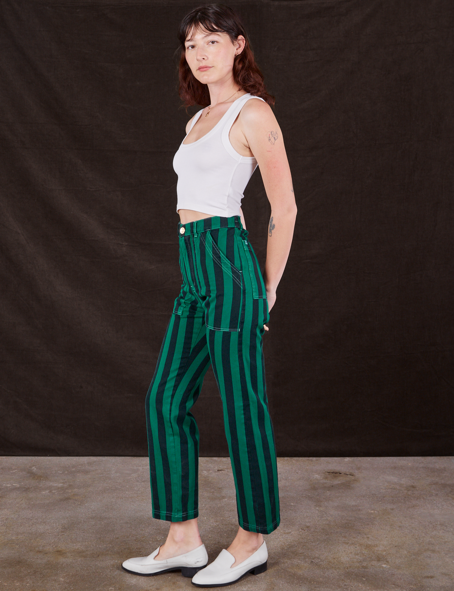 Side view of Black Stripe Work Pants in Hunter and vintage off-white Cropped Tank Top on Alex