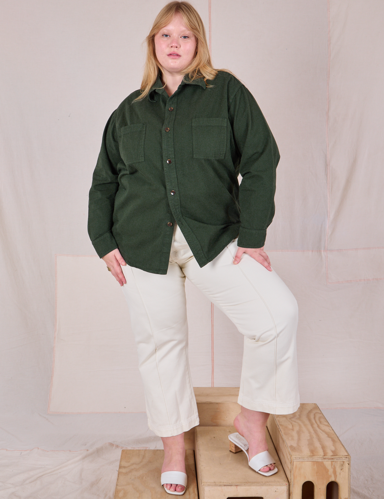 Juliet is wearing a buttoned up Twill Overshirt in Swamp Green and vintage tee off-white Western Pants