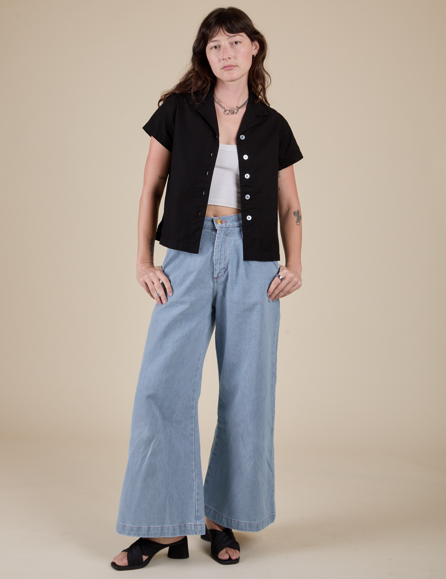 Alex is wearing Pantry Button-Up in Basic Black and light wash Indigo Wide Leg Trousers