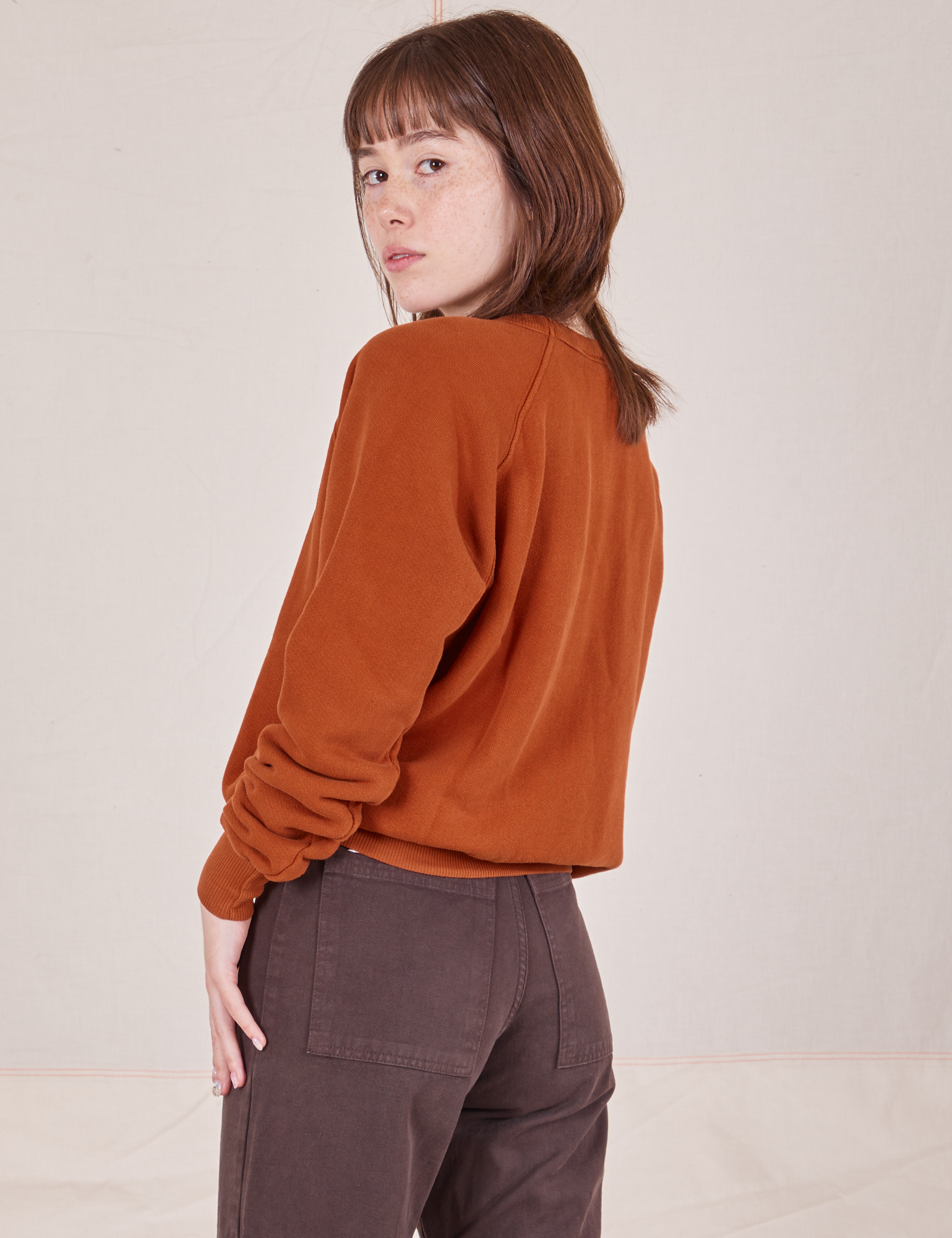 Side view of Bill Ogden&#39;s Sun Baby Crew and espresso brown Western Pants worn by Hana