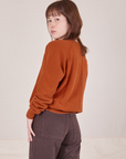 Side view of Bill Ogden's Sun Baby Crew and espresso brown Western Pants worn by Hana