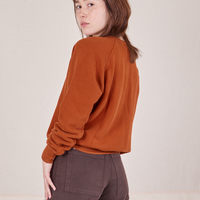 Side view of Bill Ogden's Sun Baby Crew and espresso brown Western Pants worn by Hana