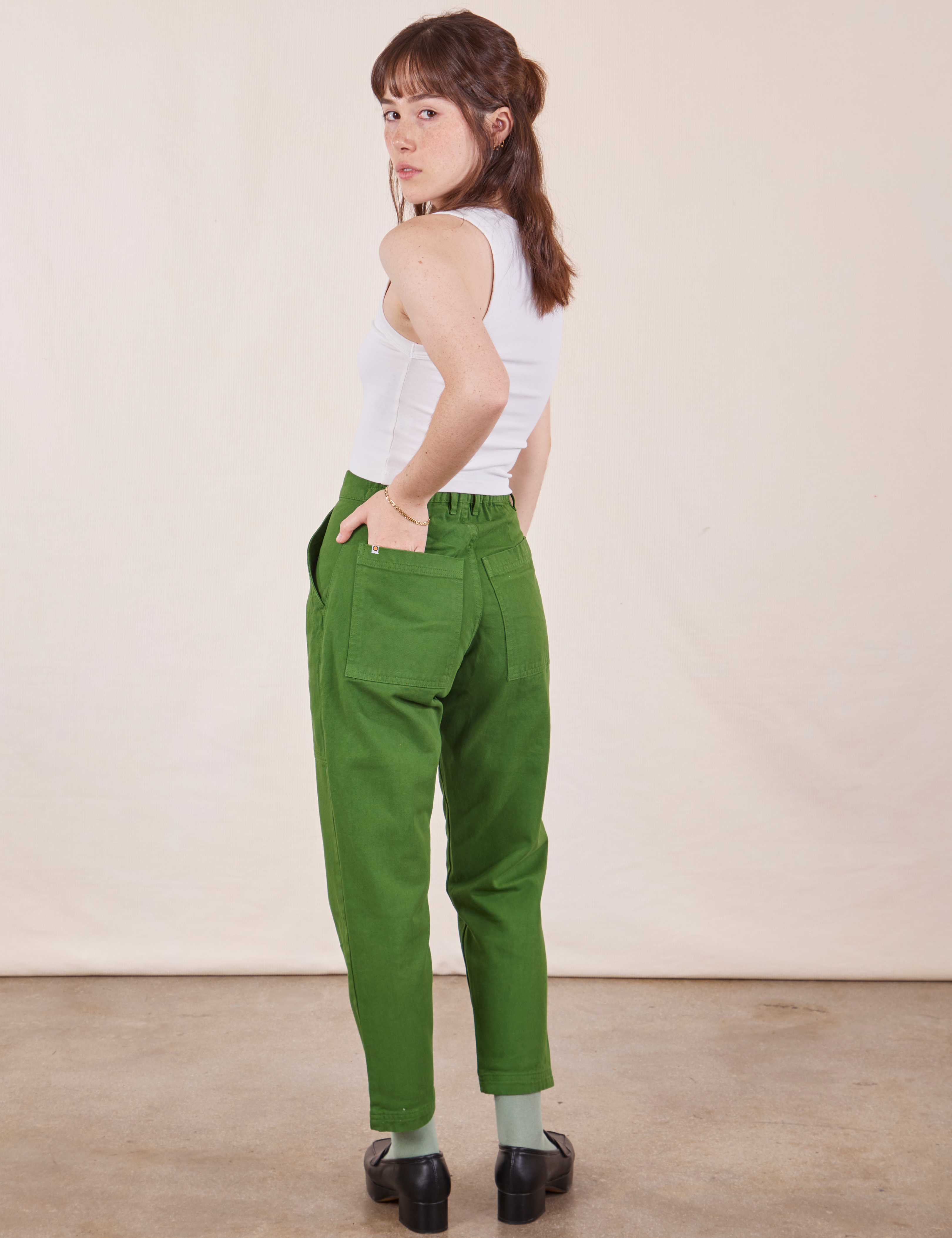 Angled back view of Petite Pencil Pants in Lawn Green on Hana